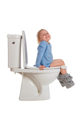 little girl is sitting on toilet