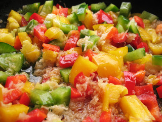 Yellow, red and green Bulgarian pepper in skillet.