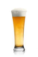 Beer into glass isolated on white