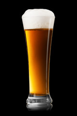 Beer into glass on a black