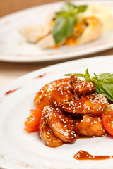 portion of sesame chicken served on a white plate
