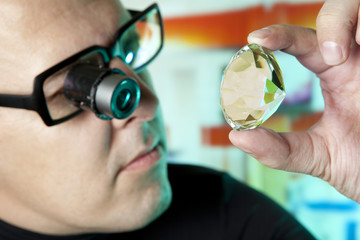 Jeweller appraising quality of diamond