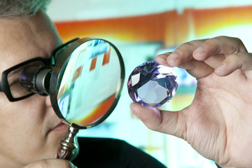 Jeweller appraising quality of diamond