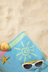 beach concept with towel and sunglasses