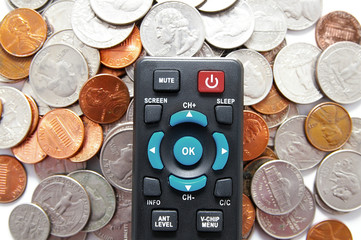 tv remote control and pile of coins