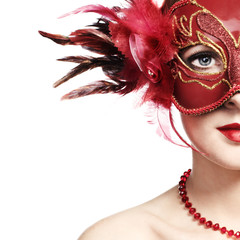 The beautiful young woman in a red mysterious venetian mask