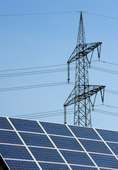 Sun panels on a roof with powercables on the background