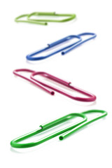 Colorful paper clips on a white background with space for text