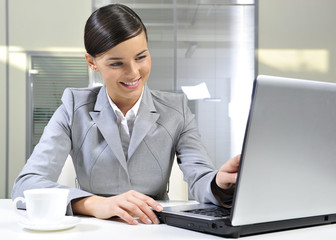 Happy businesswoman in her office