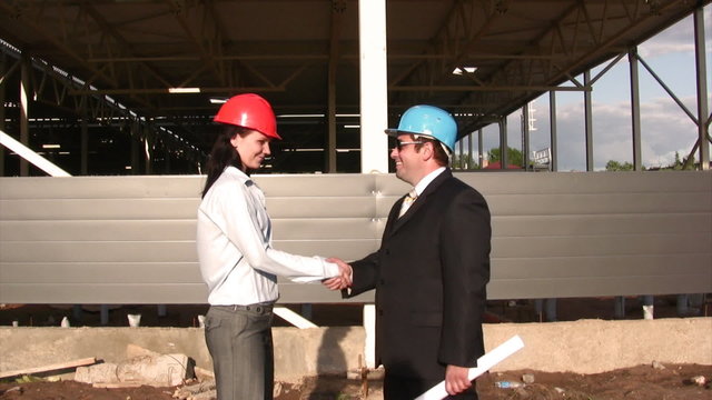 Businessteam on construction site of shopping center