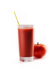 Fresh tomatoes and a glass full of tomato juice on white