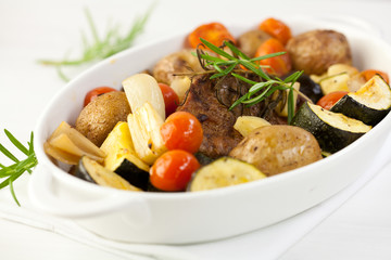 Rustic roast pork with baked vegetables and rosemary
