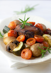 Roast pork with baked vegetables and mushrooms