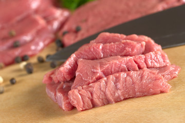 Fresh raw beef meat with knife and pepper corns