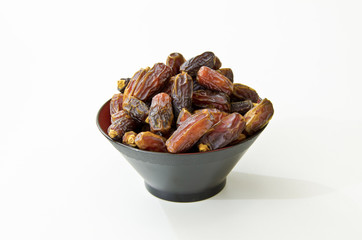 Plate full of Dates Fruit isolated on white Background