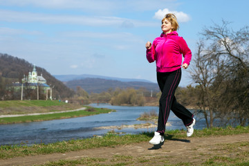 woman jogging in the park in summer