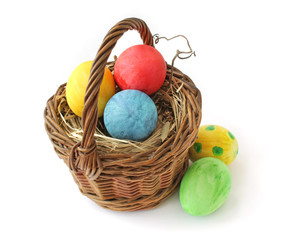 Easter Eggs in a basket on a white background