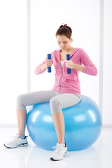 Fototapeta na wymiar Fitness woman exercise dumbbell ball gym