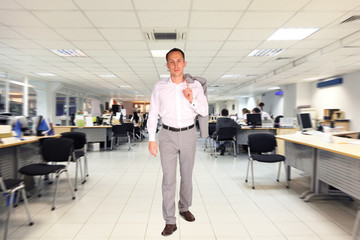 businessman walks in office with white floor and celling