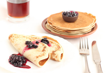 Pancakes on a plate with black current jam