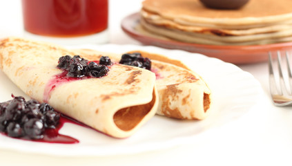 Pancakes on a plate with black current jam