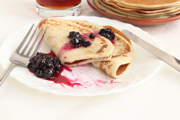 Pancakes on a plate with black current jam