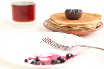 Pancakes on a plate with black current jam