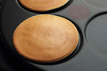 Baking pancakes on a crepe maker