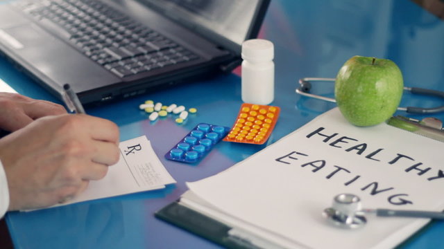 Male doctor writing rx prescription