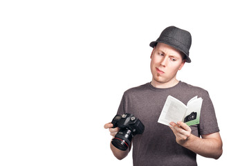 Young man confused with camera manual