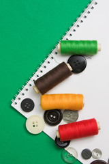 thread with a needle and buttons