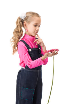 Young girl looking at flower