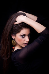 Fototapeta premium Young woman posing, on black background
