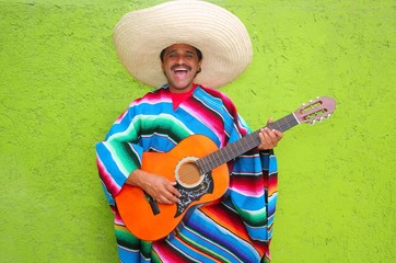 Mexican man playing guitar poncho