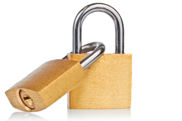 Two linked brass padlocks with reflections on a white background