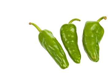 Three green peppers in a corner with copyspace