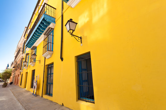 Street in Old Havana with a colorful yellow wall