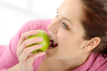 Fitness woman eat apple sportive outfit
