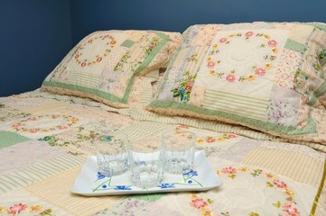 Drinking glasses on large bed