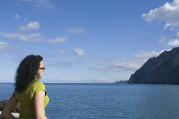 Fototapeta premium Young dark haired woman dreaming on a seashore
