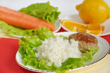 Home cooking, cutlet with rice and vegetables