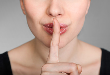 girl making a hush gesture