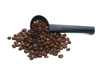 heap of coffee crops with black sspoon