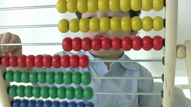 Preschool student learning  mathematics with abacus