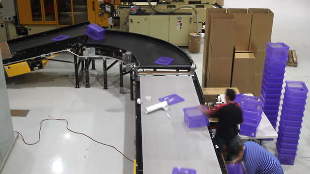 A time lapse of a factory assembly line with workers.
