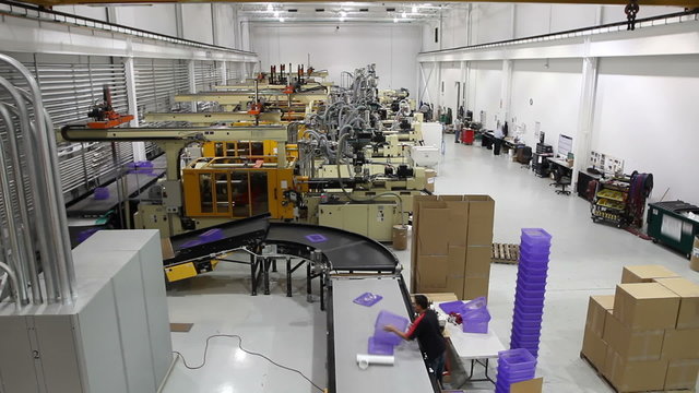 A wide shot time lapse of an entire robotics assembly plant in motion.
