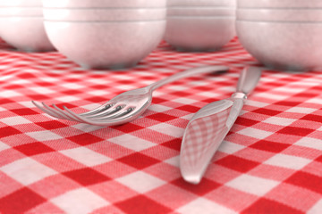 Fork and Knife closeup on a red table cloth