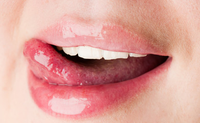 young female licking her pink lips