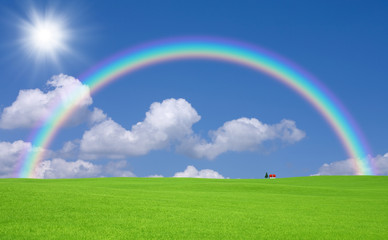 Naklejka premium Green grass and red roof house and rainbow