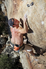 Rock climber reaching top of route